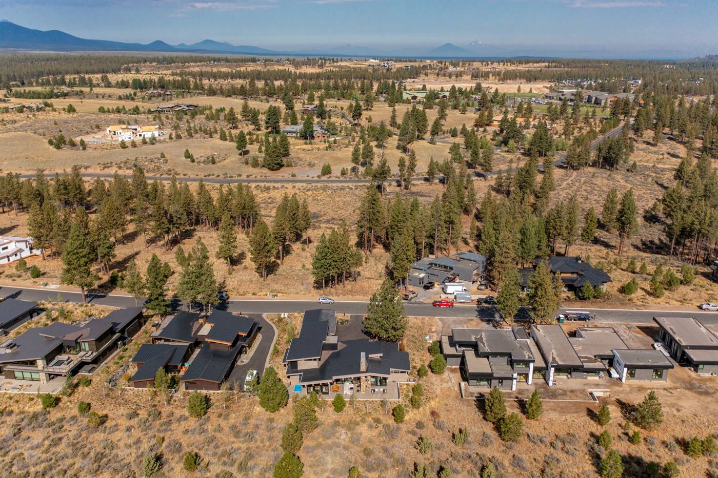 Aerial view of Tetherow homes with the Cascade Range on the horizon